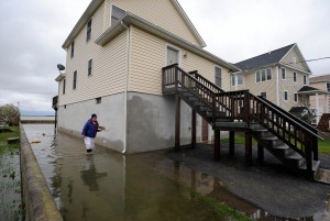 Charoene Taylor walks through flood water outside her home in the Bowleys Quarters section of Baltimore County, Md. as the aftermath of superstorm Sandy continued to disrupt routines on the East Coast Tuesday, Oct. 30, 2012. (AP Photo/Steve Ruark)