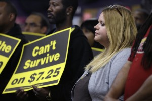 In this photo from Friday, April 25, 2014, Amy Jennewein participates in a rally in support of raising the minimum wage University City, Mo. (AP Photo/Jeff Roberson)
