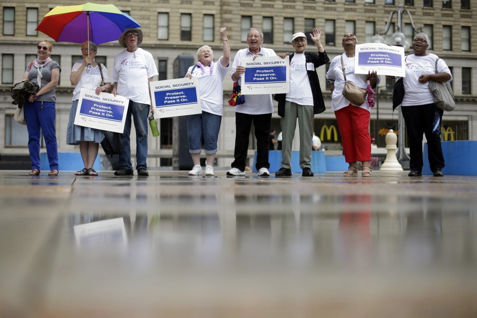 Demonstrators form a symbolic chain to protest against a proposed change in the formula for determining annual Social Security benefits known as "chained CPI," Tuesday, July 2, 2013, in Philadelphia. (AP Photo/Matt Rourke)