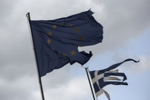 Ruined EU and Greek flags fly in tatters from a flag pole at a beach at Anavissos village, southwest of Athens, on Monday, March 16, 2015. (AP Photo/Yorgos Karahalis)