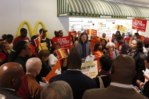 Rev. Peter Heltzel prays during a rally for a higher minimum wage outside a McDonald's restaurant at the Empire State Plaza concourse in Albany, N.Y. (AP Photo/Mike Groll, File)