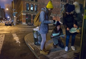 From left, Ashley Treni, Alexis Sypek, Victoria Parker and Edward Casabian, all from New York and working with The Robin Hood Foundation, an organization that helps the poor, organize papers on a street corner as they take part in a count and survey of homeless persons on the streets of New York early Tuesday, Feb. 9, 2016. Hundreds of people fanned out across the city to conduct the survey just after midnight. (AP Photo/Craig Ruttle)