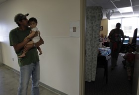 Antoine Reyes, left, who moved into a family shelter 16 months ago after losing his job, kisses his daughter Lily in Los Angeles, Thursday, Sept. 16, 2010. The ranks of the working-age poor climbed to the highest level since the 1960s as the recession threw millions of people out of work last year, leaving one in seven Americans in poverty. (AP Photo/Jae C. Hong)
