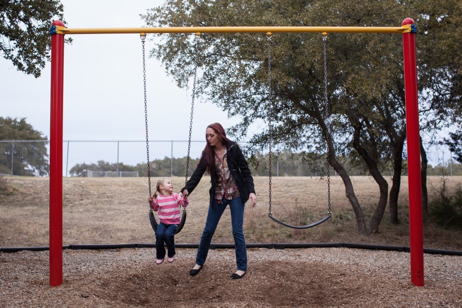 A woman plays with her three-year-old daughter in Lakeway, Texas on Saturday, Jan. 25, 2014. She enrolled in the food stamps program to help save up for paramedic training while she works as a home health aide and raises her daughter.  (AP Photo/Tamir Kalifa)