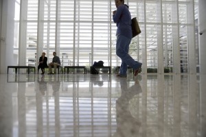 A woman walks in front of the main lobby of the University Medical Center New Orleans, during a media tour in New Orleans, Wednesday, June 17, 2015. Building the $1 billion medical complex has come about despite a yearslong fight over the extent of hurricane damage to the city's old Charity Hospital, fights over the razing of a neighborhood where the new hospital was to be built and over the objections of many in the medical community. (AP Photo/Gerald Herbert)