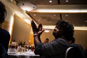 A senior citizen clapping.