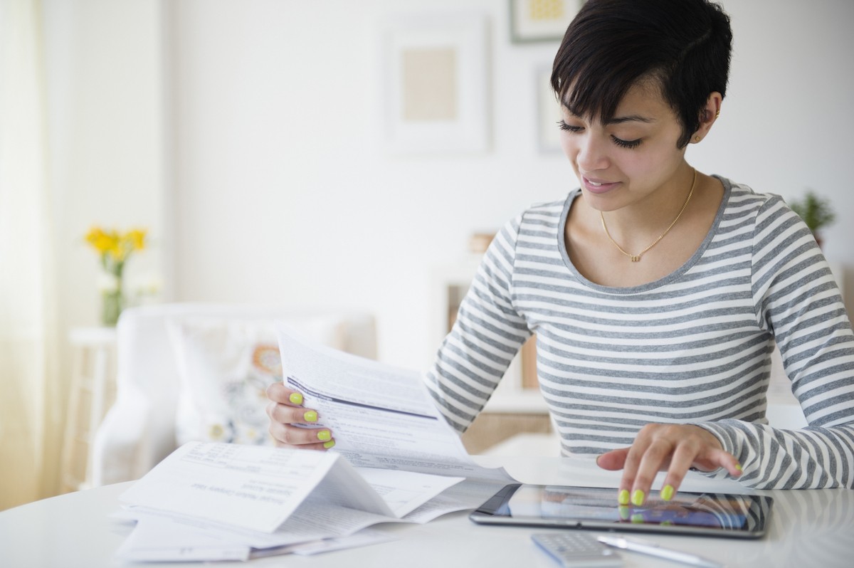 A woman reviewing bills.