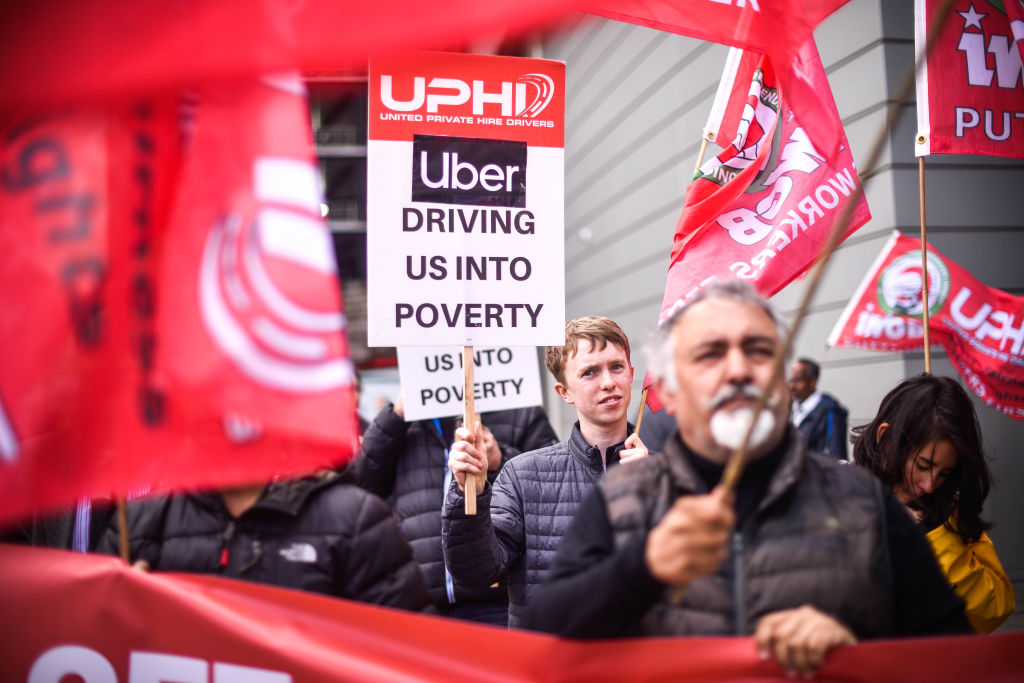 uber drivers carrying protest signs