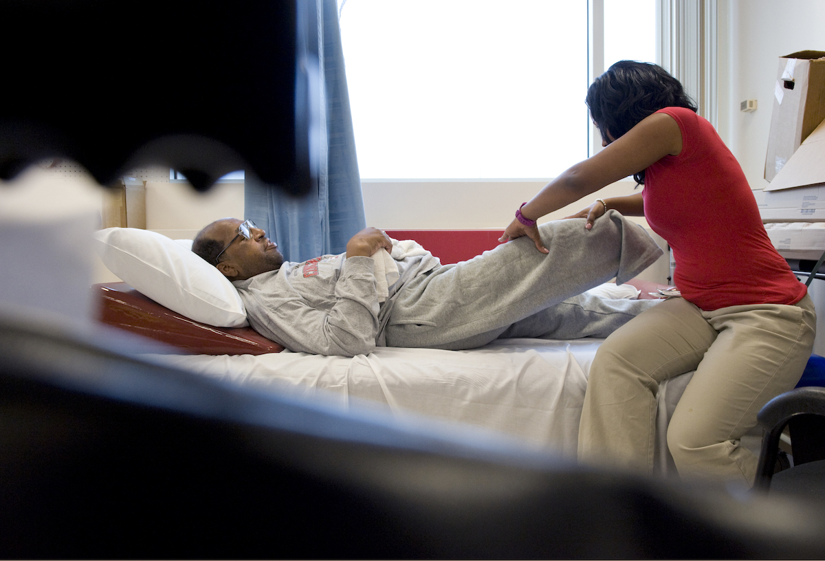 A physical therapist and patient