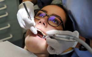 A dentist examining a patient.