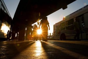 a bus idling at a curb
