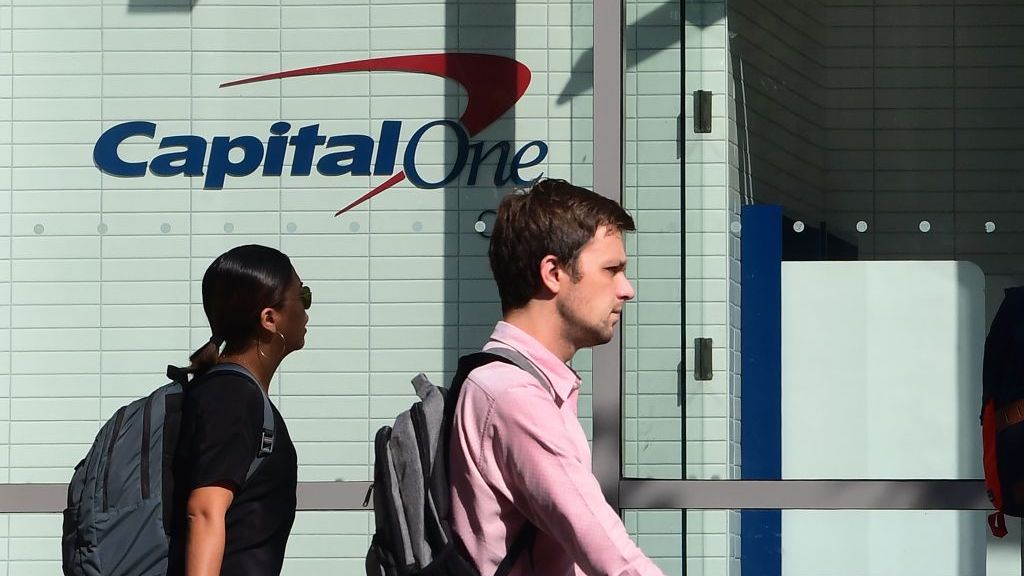 pedestrians pass a bank