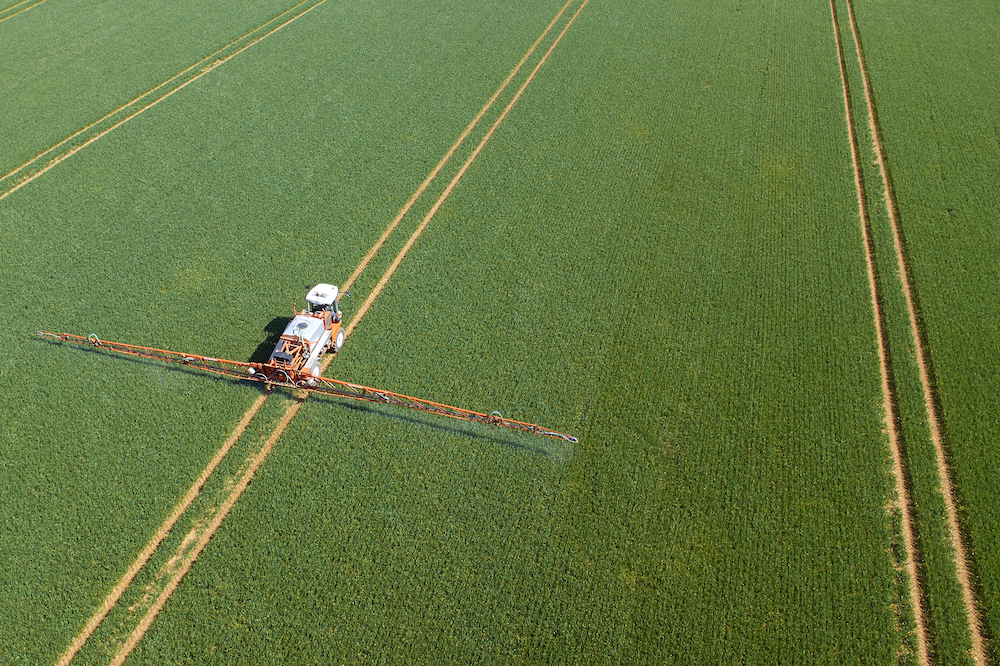 A crop sprayer applying pesticides.