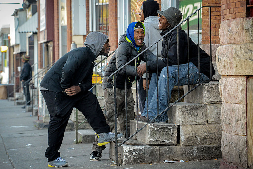 a group of young black men smiling and talking