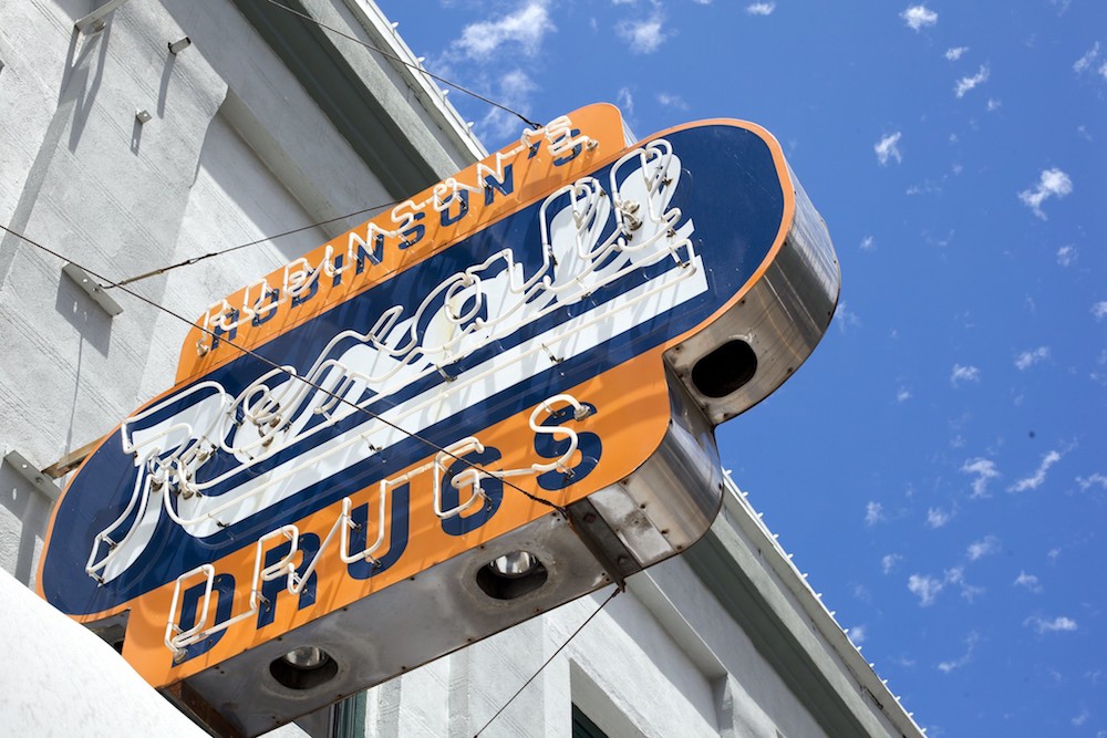 a sign advertising the rexall drug store