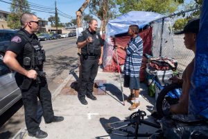 Police talking to an unhoused person.