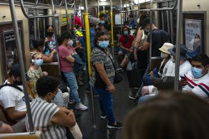 Passengers on the subway wear face masks