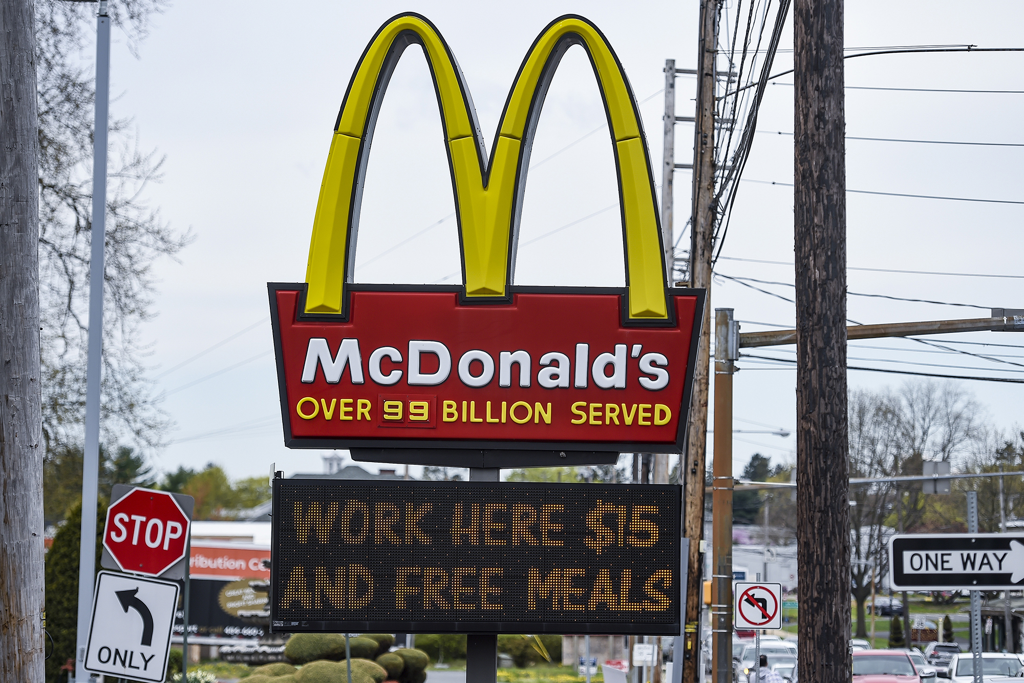 A McDonald's sign advertising jobs at $15 hourly plus free meals